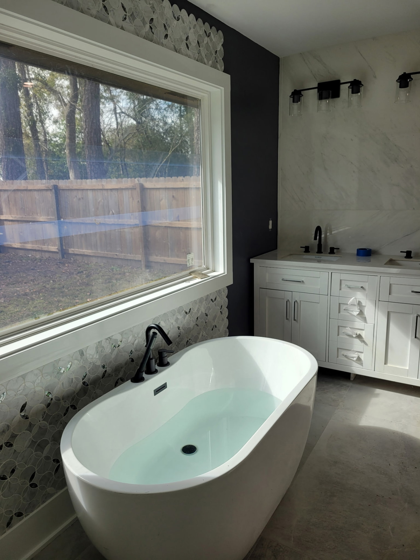 Freestanding soaking tub and double vanity plumbing in a Northshore Louisiana master bathroom remodel